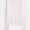 Baby-T-shirt met lange mouwen, naadloze stof en vierkante hals Baby-T-shirt met lange mouwen, naadloze stof en vierkante hals