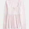Babydoll-top met lange mouwen en henleykraag Babydoll-top met lange mouwen en henleykraag