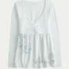Babydoll-top met lange mouwen, grafische print en geplooide buste Babydoll-top met lange mouwen, grafische print en geplooide buste