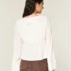 Gemakkelijke babydolltop met lange mouwen en ruches Gemakkelijke babydolltop met lange mouwen en ruches