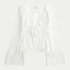 Gemakkelijke babydolltop met lange mouwen en ruches Gemakkelijke babydolltop met lange mouwen en ruches