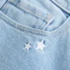Laag uitgesneden bootcut jeans met sterrenborduursel Laag uitgesneden bootcut jeans met sterrenborduursel