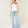 Laag uitgesneden lichtgewassen baggy jeans met studs en strikken Laag uitgesneden lichtgewassen baggy jeans met studs en strikken