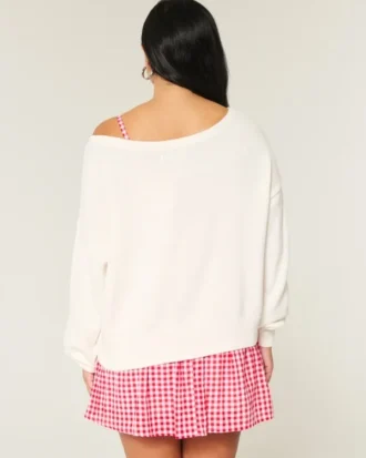 Slouchy off-shoulder trui met hartjesprint