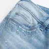 Ultra laag getailleerde distressed lichtgewassen flare jeans met pailletten Ultra laag getailleerde distressed lichtgewassen flare jeans met pailletten