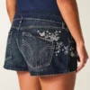 Ultra laag uitgesneden donkerblauwe denim minishort met vlinderborduursel Ultra laag uitgesneden donkerblauwe denim minishort met vlinderborduursel