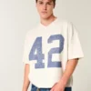 Zwaar baggy cropped varsity T-shirt met voetbalprint Zwaar baggy cropped varsity T-shirt met voetbalprint